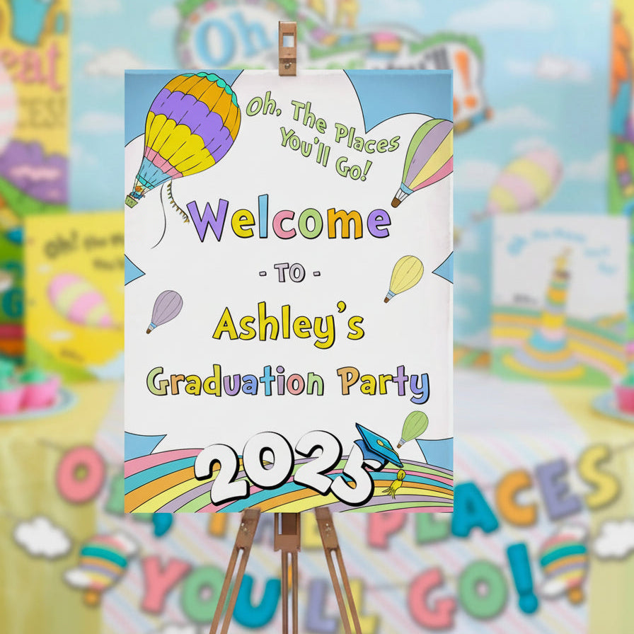 Graduation party sign with colorful balloons and text on a stand, surrounded by similar signs and decorations.